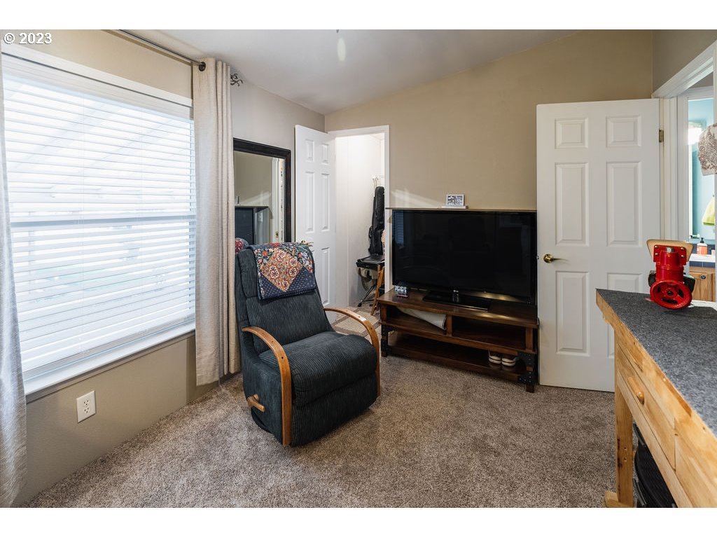 369 Gun Club Road, Unit 16 Woodland, WA 98674 - Photo 24 of 44 a living room with furniture and a flat screen tv