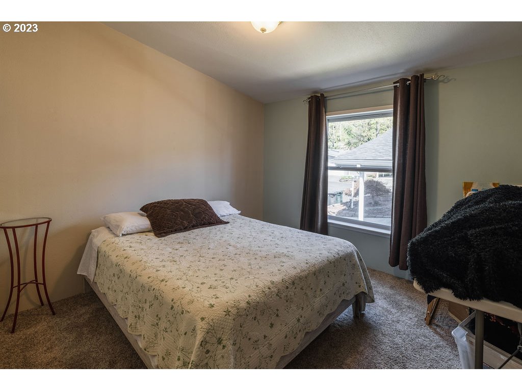 369 Gun Club Road, Unit 16 Woodland, WA 98674 - Photo 26 of 44 a bedroom with a bed and a window