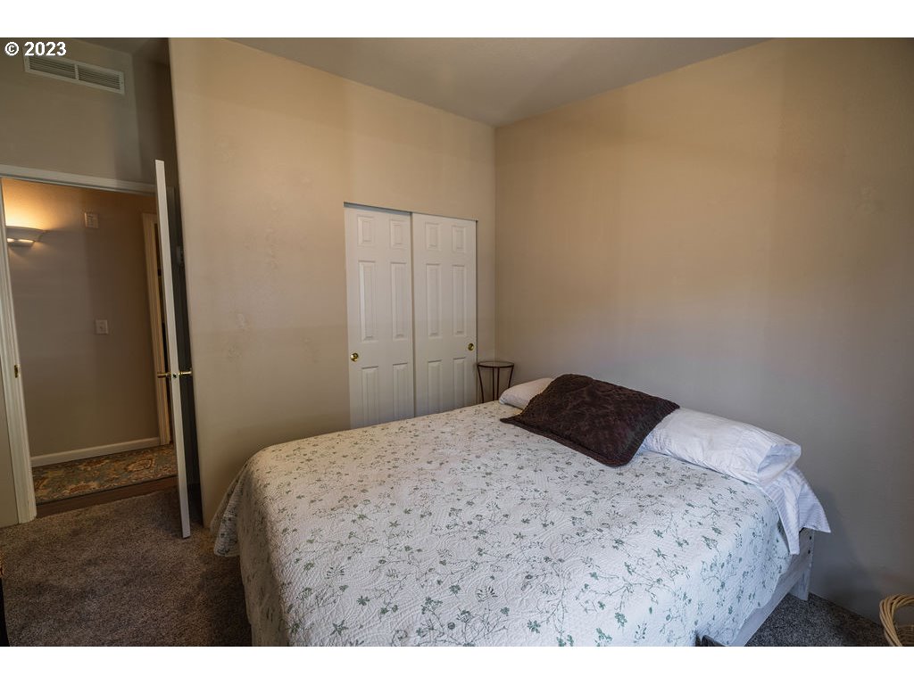 369 Gun Club Road, Unit 16 Woodland, WA 98674 - Photo 27 of 44 a bedroom with a bed and a closet