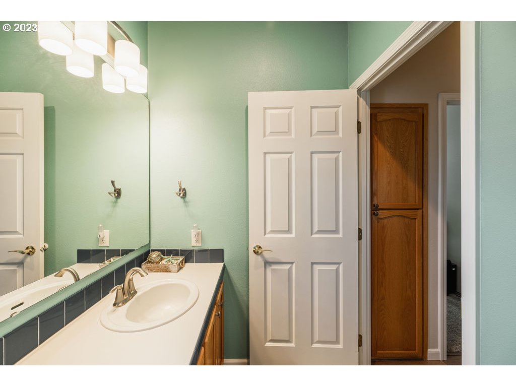 369 Gun Club Road, Unit 16 Woodland, WA 98674 - Photo 30 of 44 a bathroom with a sink and a mirror