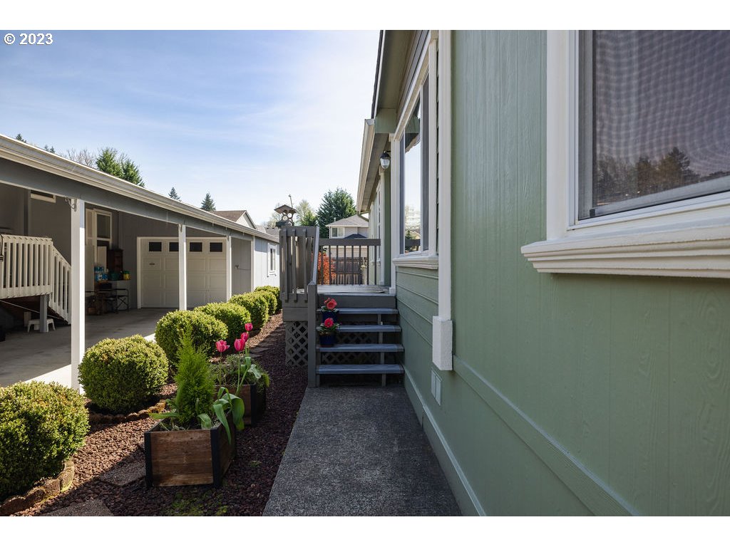369 Gun Club Road, Unit 16 Woodland, WA 98674 - Photo 5 of 44 a view of a house with a flower garden
