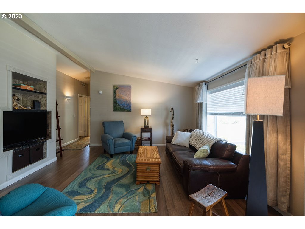 369 Gun Club Road, Unit 16 Woodland, WA 98674 - Photo 8 of 44 a living room with furniture and a flat screen tv