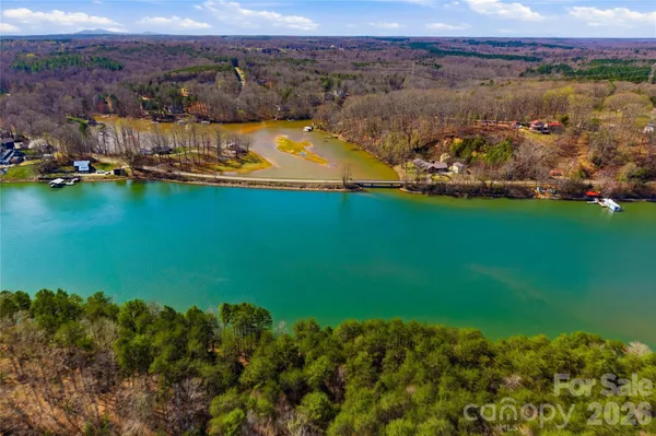 an aerial view of a houses with a lake view