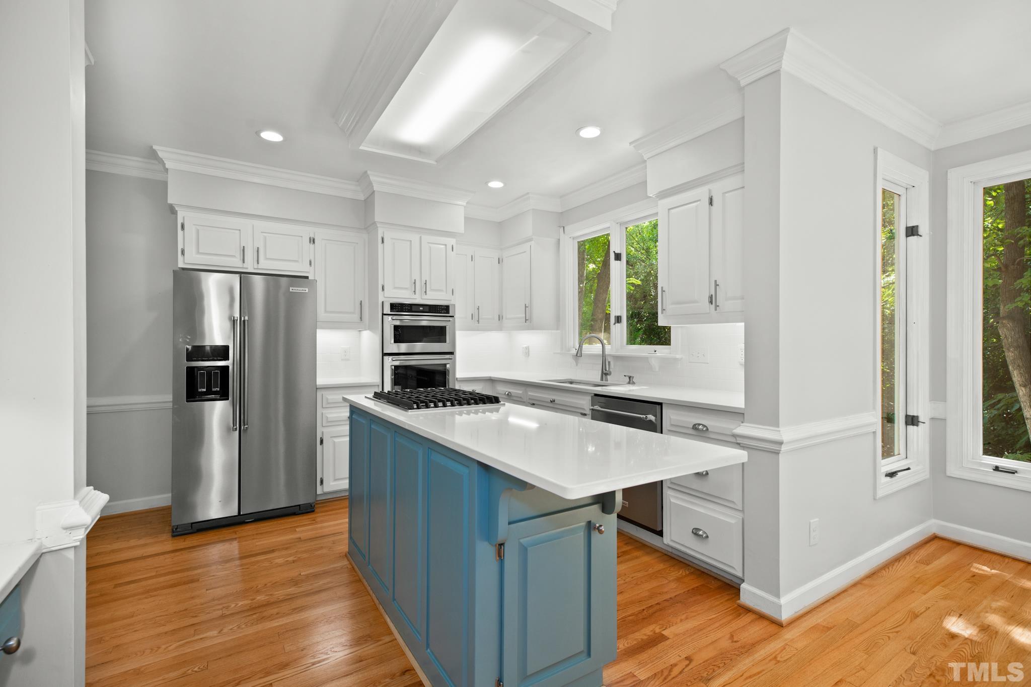 1205 Weldon Place Raleigh, NC 27608 - Photo 19 of 33 a kitchen that has a cabinets a sink and a stove in it