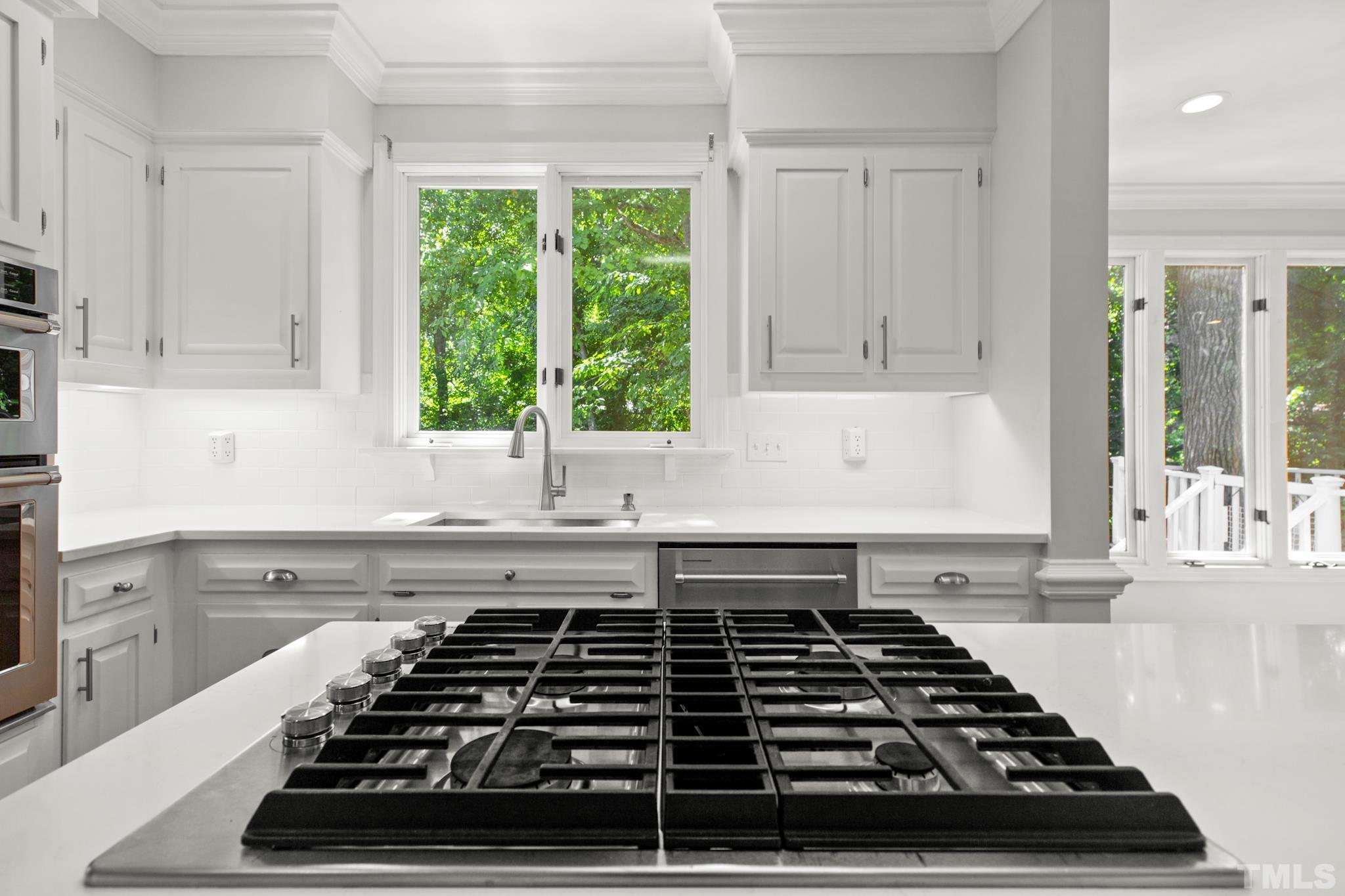 1205 Weldon Place Raleigh, NC 27608 - Photo 21 of 33 a kitchen with wooden cabinets and a stove