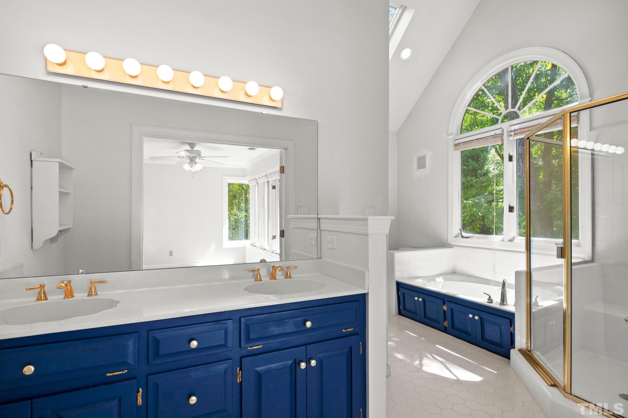 1205 Weldon Place Raleigh, NC 27608 - Photo 28 of 33 a spacious bathroom with a double vanity sink and a mirror