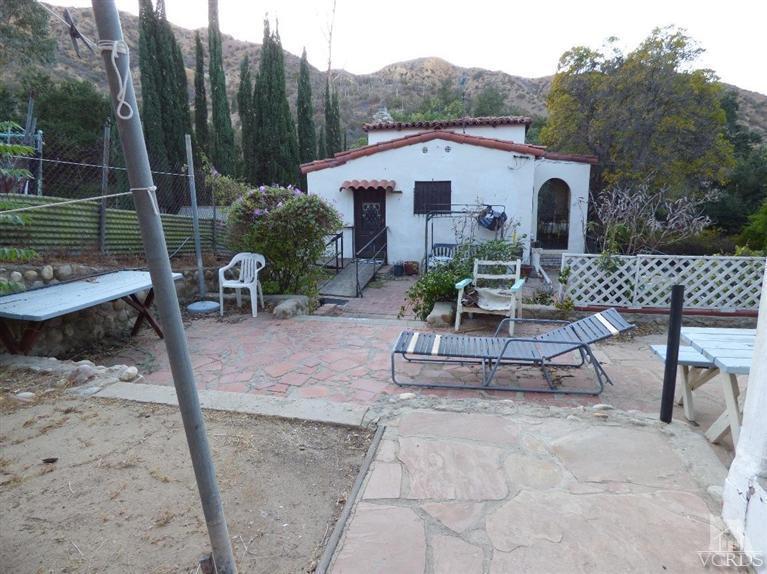 952 Riess Road Simi Valley, CA 93063 - Photo 14 of 25 a view of a patio with couches table and chairs under an umbrella