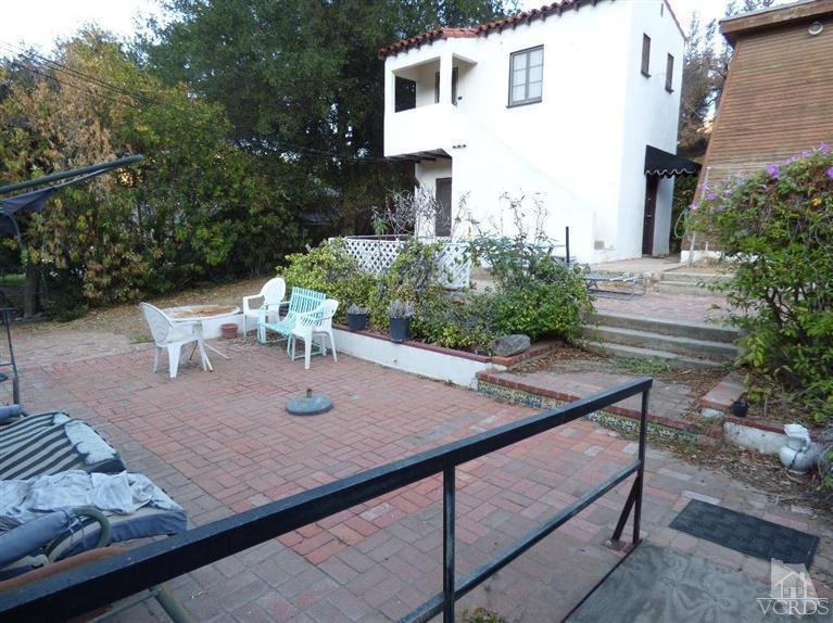 952 Riess Road Simi Valley, CA 93063 - Photo 15 of 25 a view of backyard with seating space and trees in the background