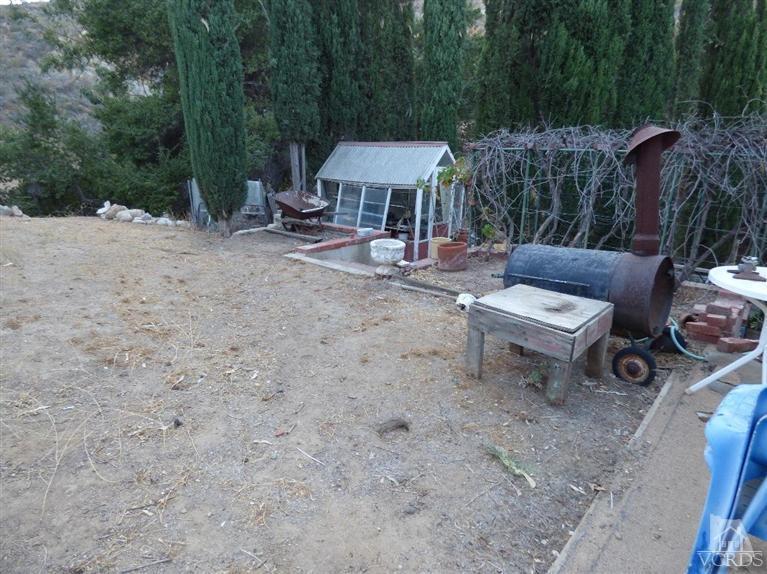 952 Riess Road Simi Valley, CA 93063 - Photo 19 of 25 a view of a patio with a table and chairs under an umbrella