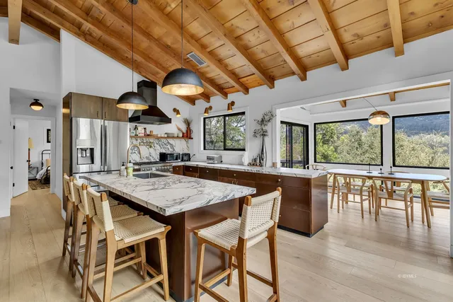 a bed sitting in a bedroom next to a window with wooden floor