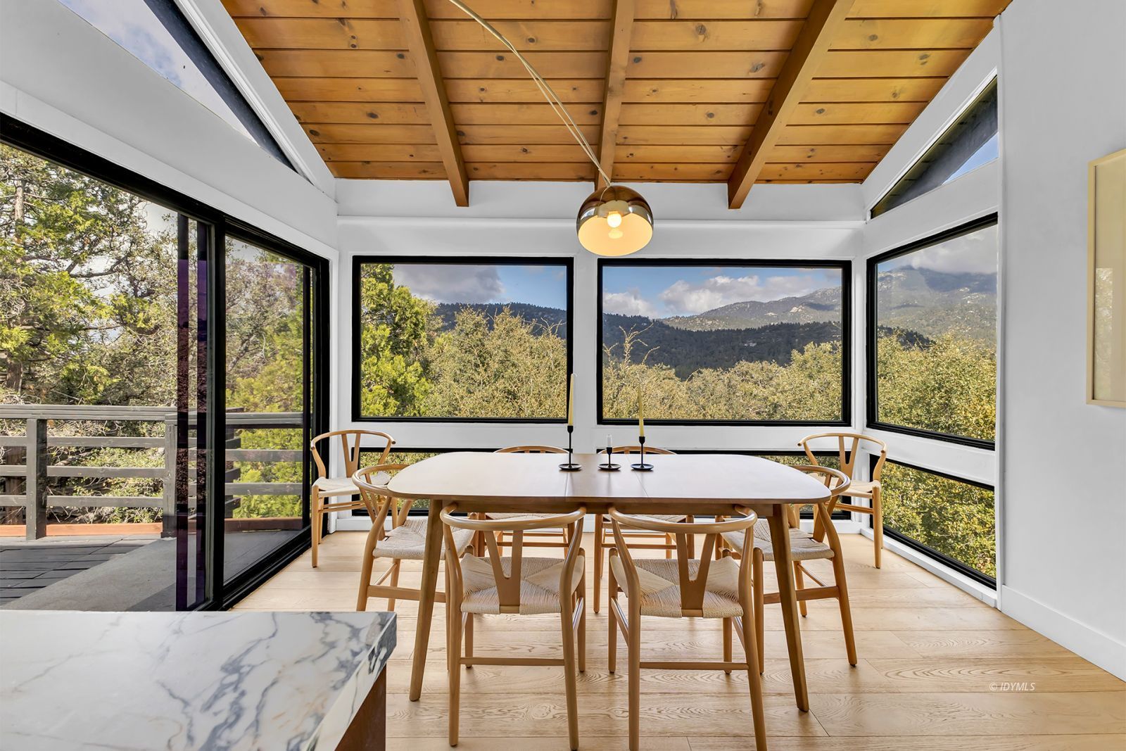 53010 Inspiration Lane Idyllwild, CA 92549 - Photo 24 of 91 a view of a dining room with furniture large windows and wooden floor