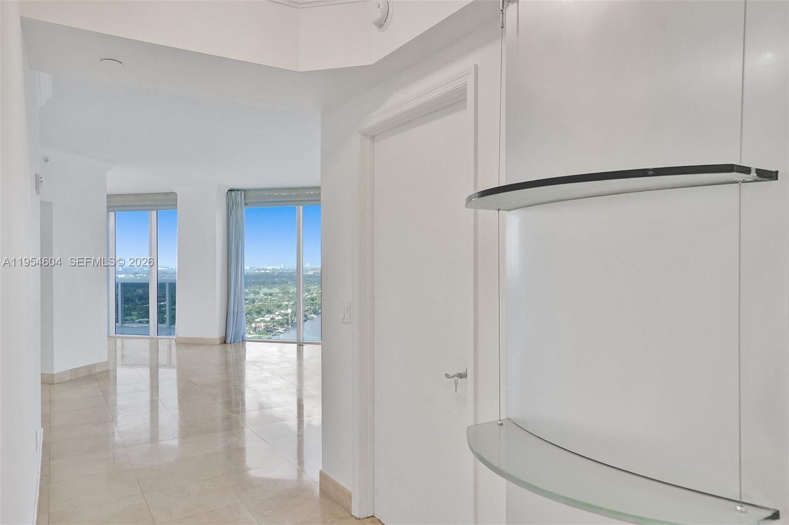 4775 Collins Avenue, Unit 3007 Miami Beach, FL 33140 - Photo 23 of 60 a view of an empty room with glass door