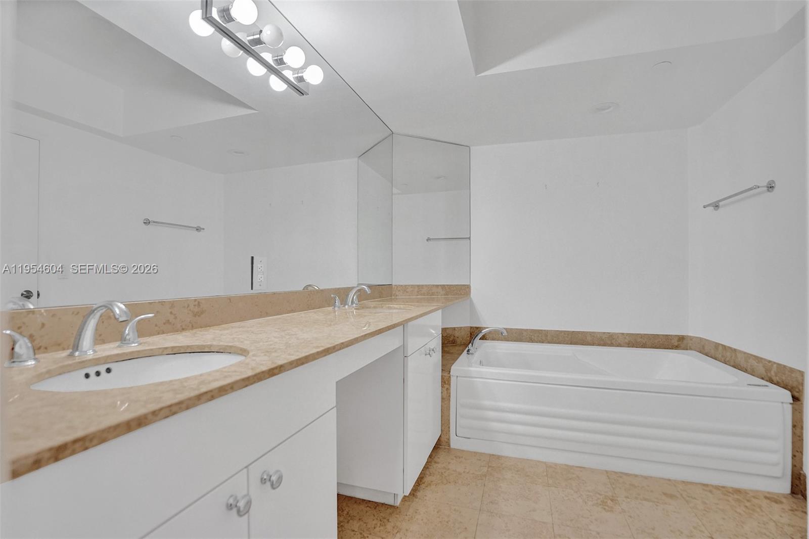 4775 Collins Avenue, Unit 3007 Miami Beach, FL 33140 - Photo 34 of 60 a bathroom with a sink a vanity and a mirror