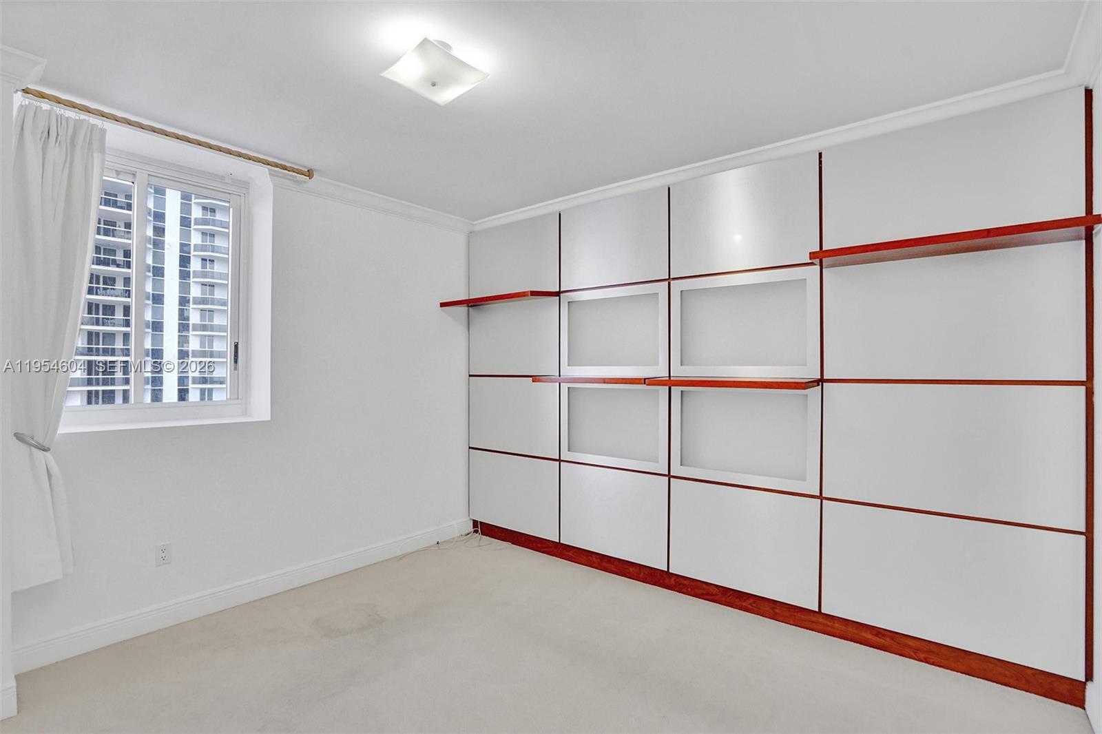 4775 Collins Avenue, Unit 3007 Miami Beach, FL 33140 - Photo 36 of 60 a view of a room with rack on the wall and a window