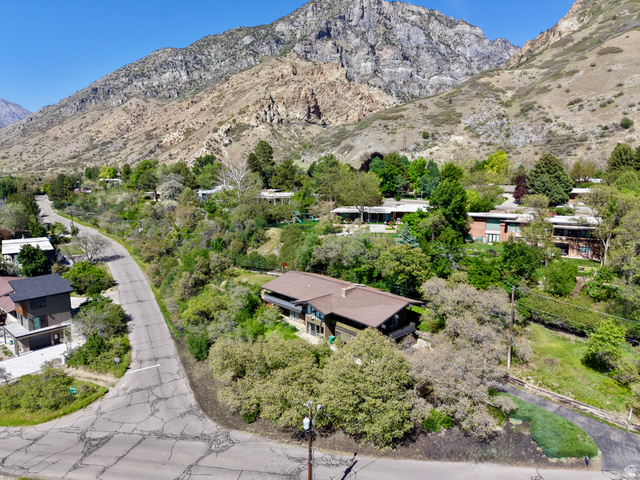 1900 North 100 East Provo, UT 84604 - Photo 48 of 49 Aerial perspective showcasing a property nestled into a verdant hillside with mature trees and mountain scenery