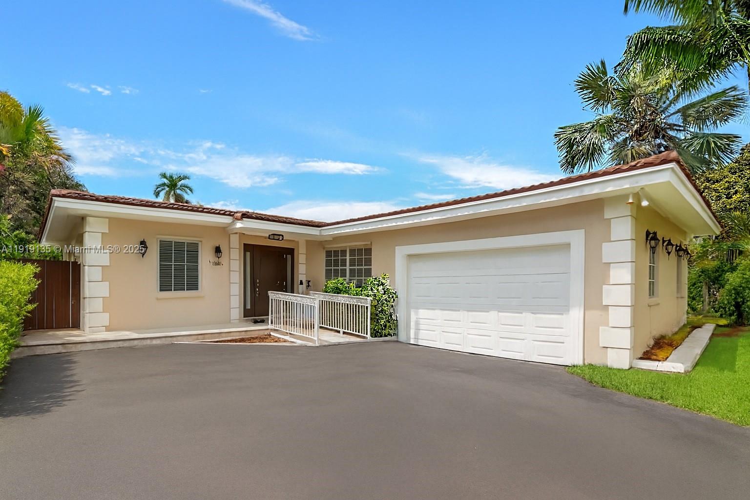 a view of a house with a yard and garage