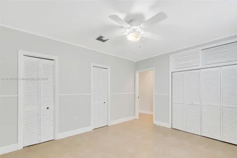 an empty room with a ceiling fan