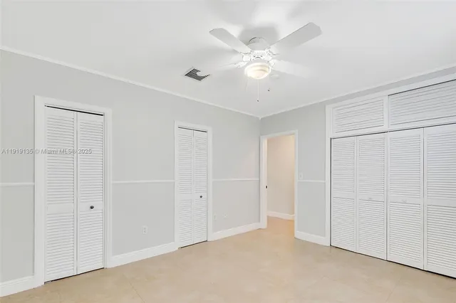 an empty room with a ceiling fan