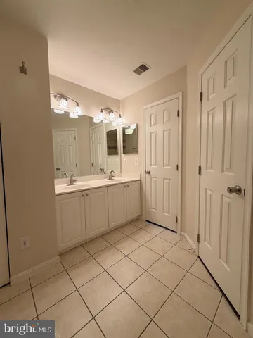 a bathroom with a sink a mirror and a shower