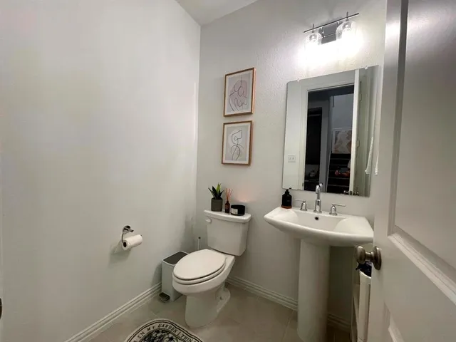 a living room with furniture and a ceiling fan