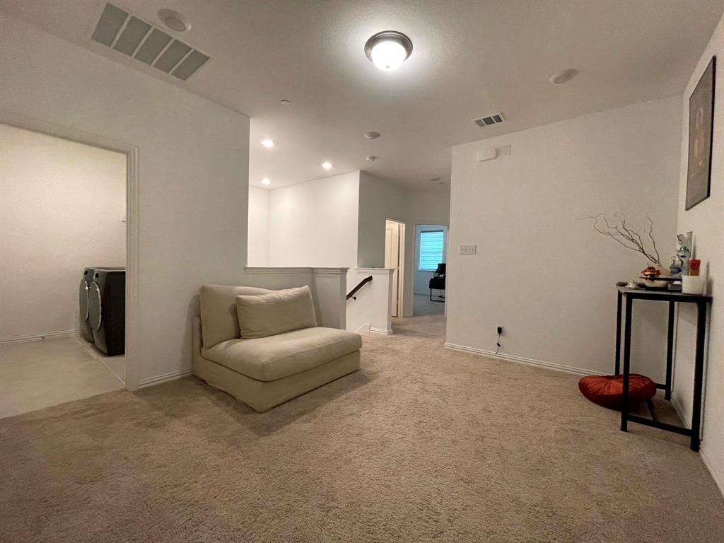 5514 Union Street Sachse, TX 75048 - Photo 13 of 25 a living room with furniture a air conditioner vent and a flat screen tv