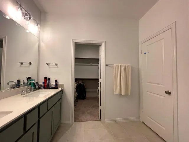 a en suite bathroom with a sink double vanity and a mirror