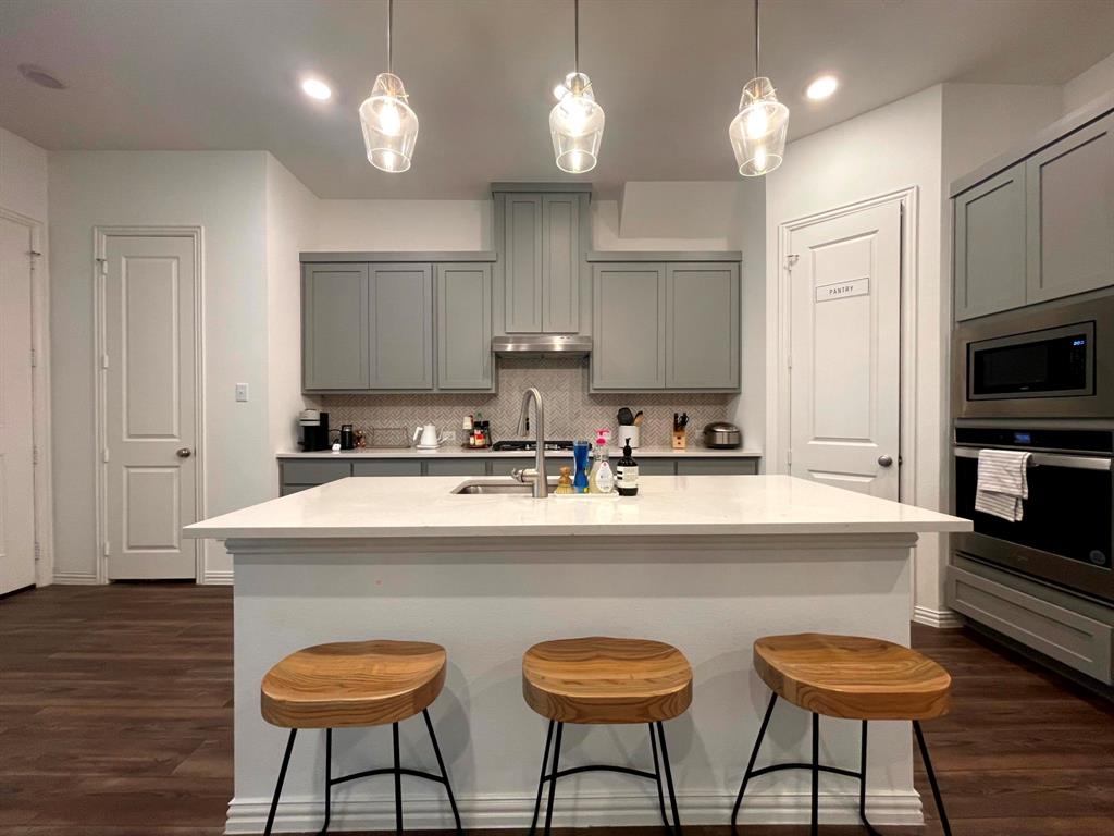 5514 Union Street Sachse, TX 75048 - Photo 5 of 25 a kitchen with stainless steel appliances a stove a sink and a refrigerator