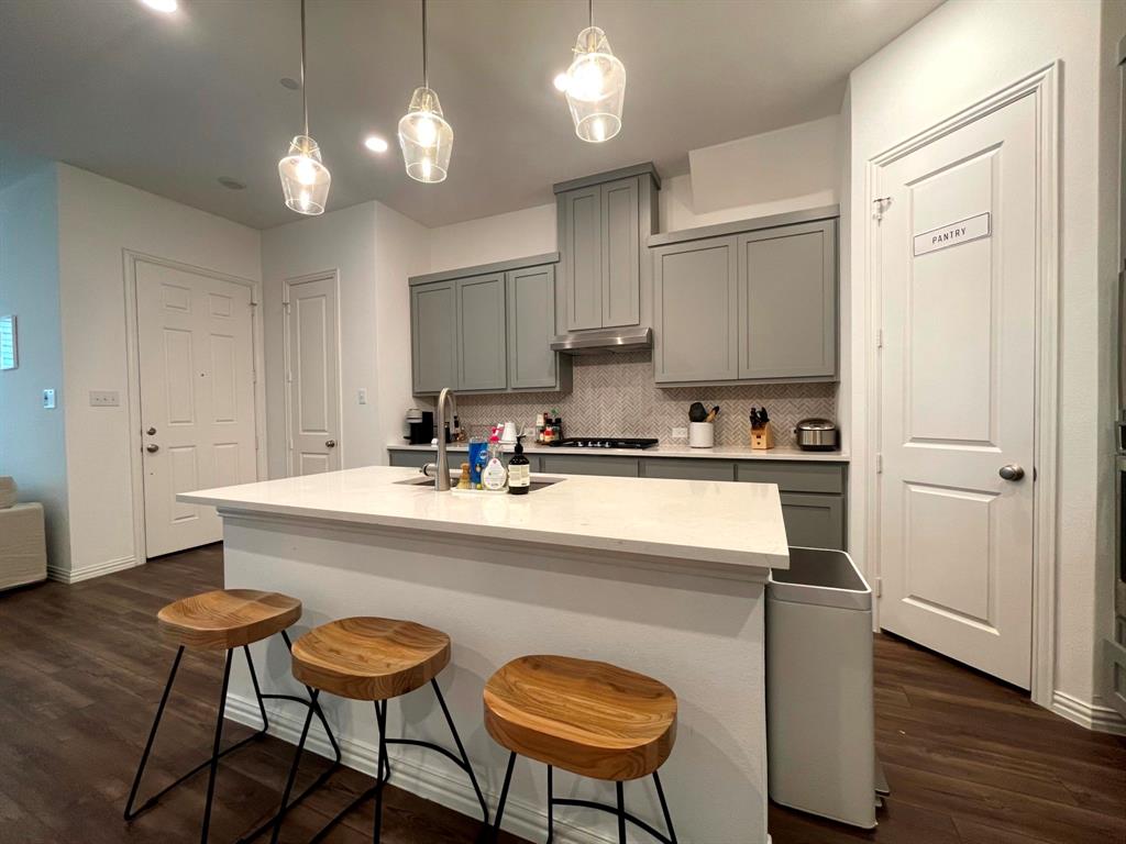 5514 Union Street Sachse, TX 75048 - Photo 8 of 25 a kitchen with stainless steel appliances granite countertop a sink a stove a refrigerator and island with wooden floor