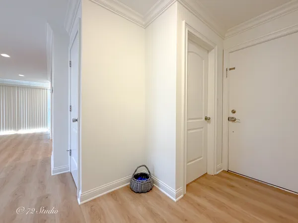 a view of a hallway with wooden floor