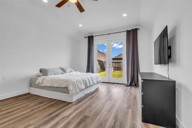 a spacious bedroom with a bed and a large window