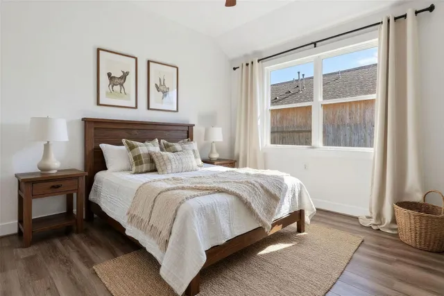 a en suite bathroom with a granite countertop double vanity sink a mirror and a bathtub
