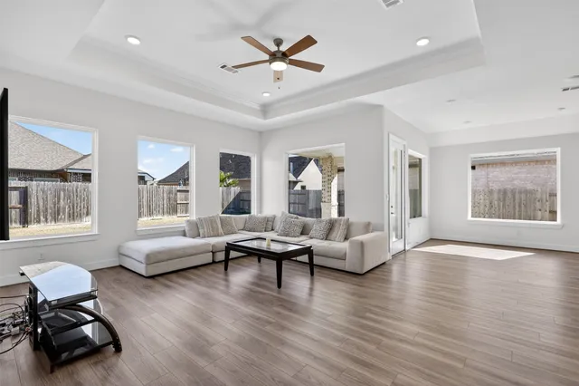 a living room with furniture and wooden floor