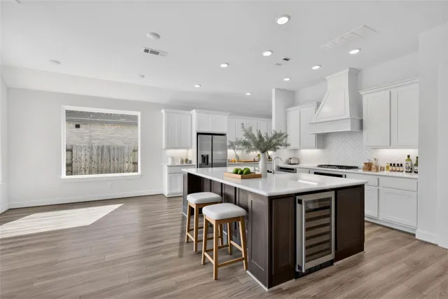 a kitchen with a sink and chairs