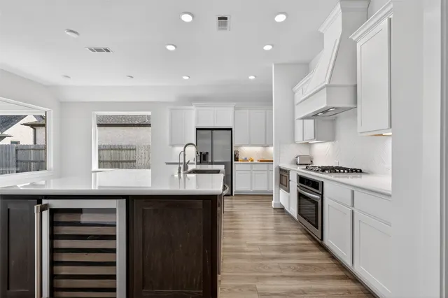 a kitchen with cabinets and stainless steel appliances