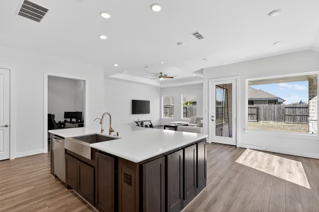 a kitchen with sink stove and refrigerator