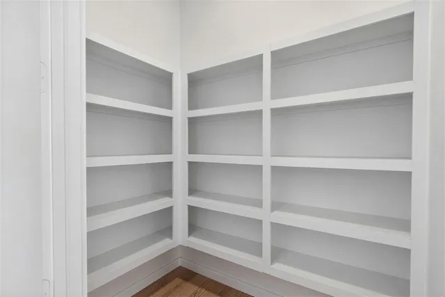 a view of walk in closet with empty racks