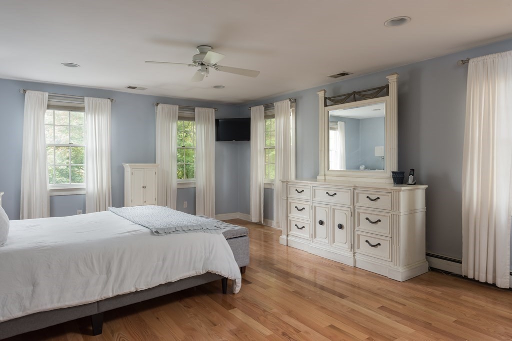 693 Point Road Marion, MA 02738 - Photo 16 of 36 a bedroom with a large bed and a dresser