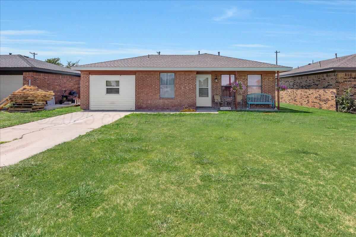 607 Groom Avenue Panhandle, TX 79068 - Photo 1 of 18 a front view of a house with a yard
