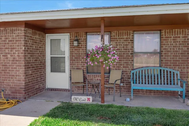 a view of a porch with a chairs and a yard