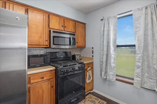 a kitchen with a stove microwave and refrigerator