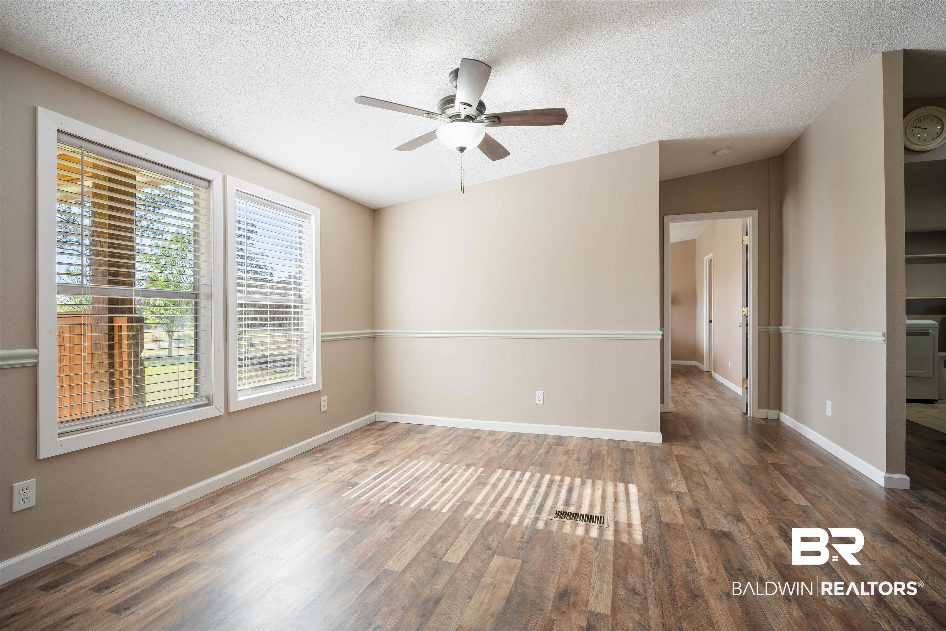9011 Wilmer Georgetown Road Wilmer, AL 36587 - Photo 24 of 34 Unfurnished room with a textured ceiling, baseboards, wood finished floors, and a ceiling fan