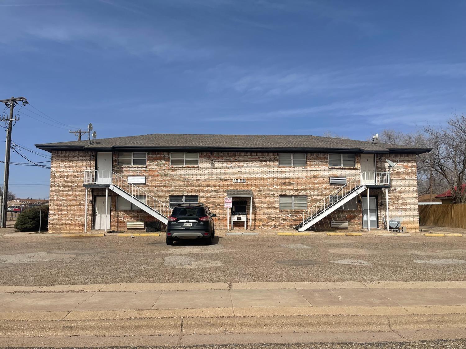 1310 54th Street, Unit 5 Lubbock, TX 79412 - Photo 1 of 8 a view of car parked on the side of the road