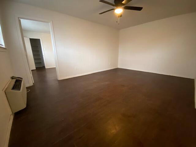 1310 54th Street, Unit 5 Lubbock, TX 79412 - Photo 5 of 8 an empty room with a ceiling fan and a window