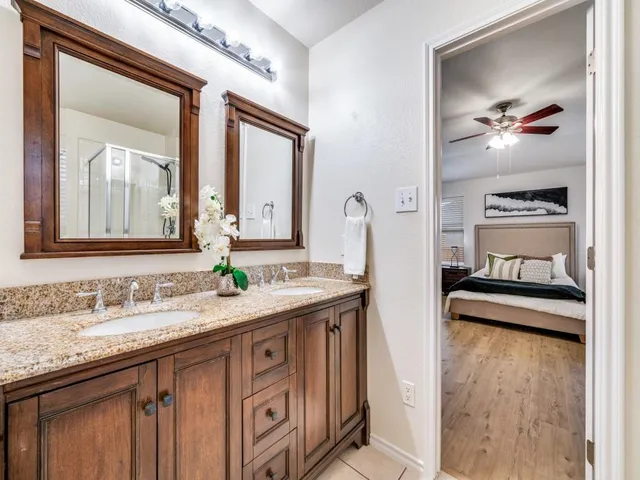 a bathroom with a double vanity sink and a mirror