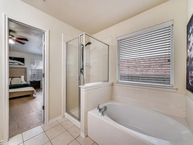 a bathroom with a tub shower and a sink
