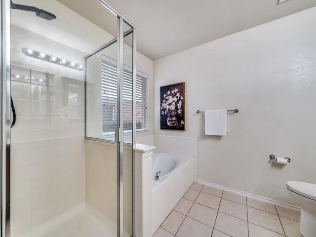 a bathroom with a bathtub and shower