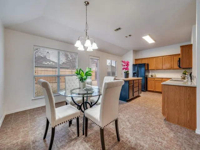 a view of a dining room with furniture and chandelier