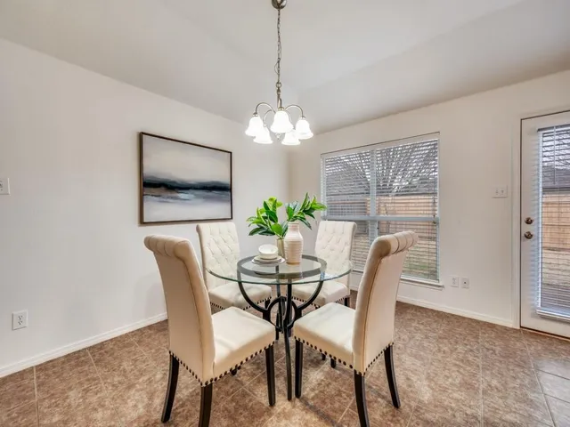 a dining room with furniture and window