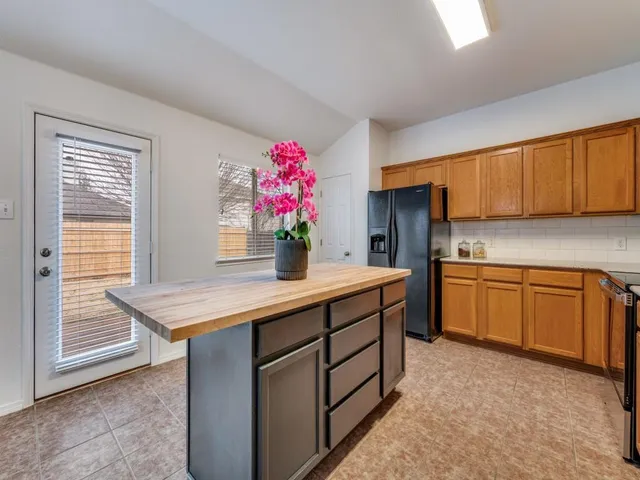 a kitchen with granite countertop a sink stainless steel appliances and cabinets