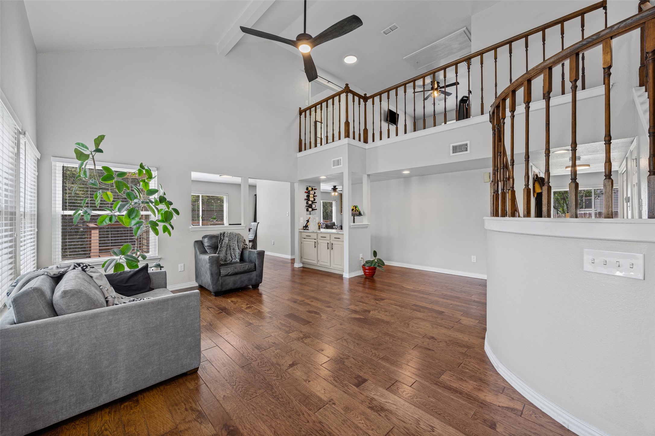 3011 Wadsworth Way Austin, TX 78748 - Photo 5 of 35 A spacious living room features soaring ceilings, rich hardwood flooring, and a second-story overlook.